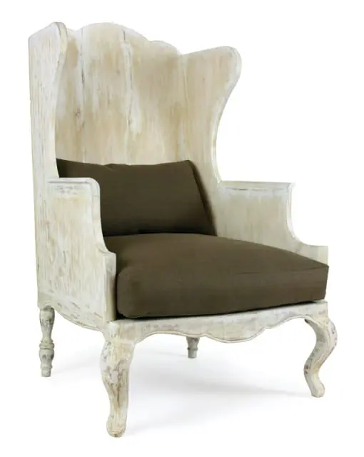 Distressed white wooden wingback chair with a dark brown upholstered seat cushion and throw pillow, set against a white background.