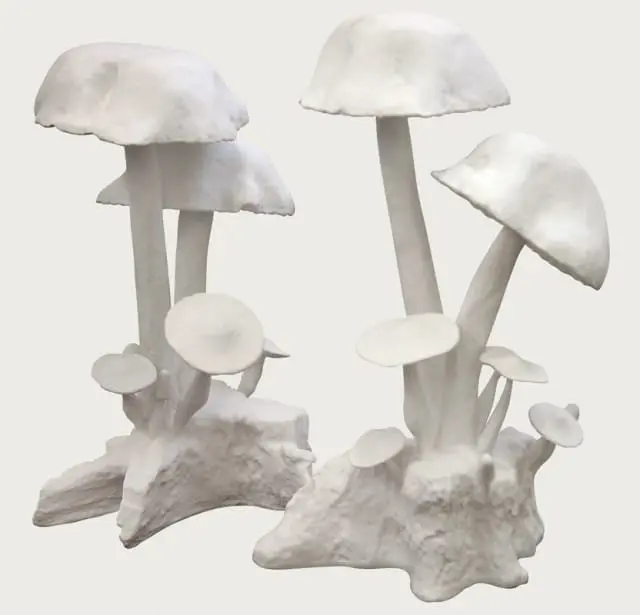 Two arrangements of white ceramic mushroom sculptures with textured bases resembling tree stumps.