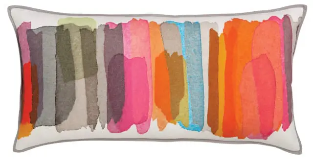 Rectangular pillow with abstract watercolor brushstrokes in shades of pink, orange, blue, green, and gray on a white background, with gray piping.