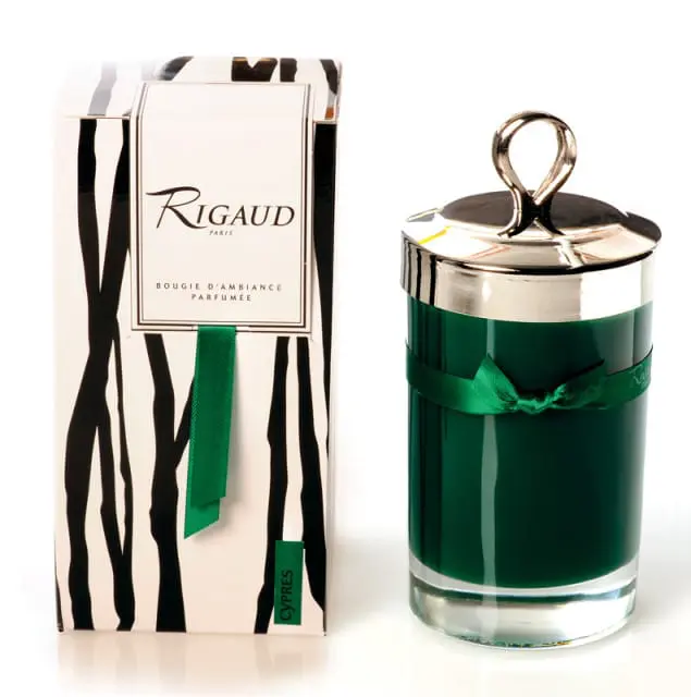 Green scented candle in glass jar with silver lid and handle, next to its black and white striped box with green ribbon and text "Rigaud Paris Bougie D'Ambiance Parfumee Cypres"