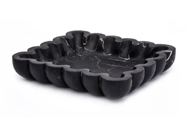 Black marble bowl with scalloped edges and white veining