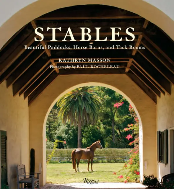 Cover of 'STABLES' by Kathryn Masson, featuring a horse in a grassy paddock framed by an arched entryway with a palm tree and pink flowers.