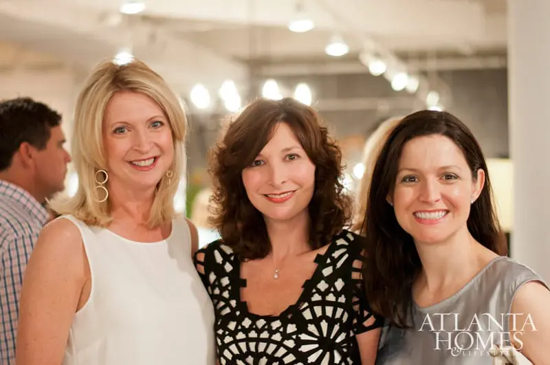 Three women smiling, with the Atlanta Homes & Lifestyles logo visible on the right.