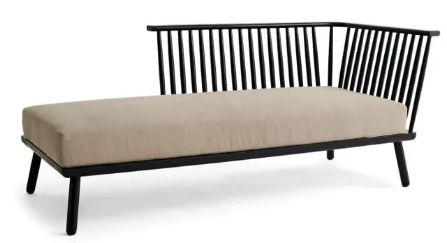 Black spindle-back bench with a light beige linen upholstered seat and black tapered legs, isolated on a white background.