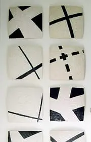 Collection of twelve square ceramic tiles with rounded corners, each featuring abstract black line designs on a textured white background.