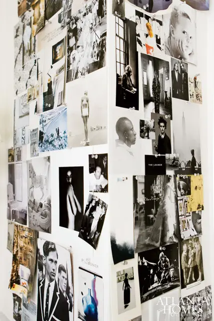 Wall covered in black and white photographs and magazine clippings, including portraits, fashion shots, and architectural images.