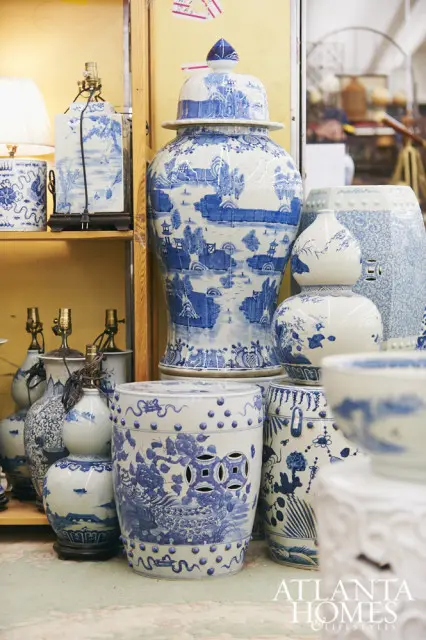 Collection of blue and white porcelain decorative items including a large ginger jar, garden stools, and vases with landscape and floral motifs.