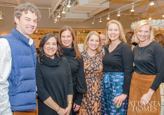 Six people posing for a photo indoors, with a logo for Atlanta Homes & Lifestyles visible in the lower right corner.