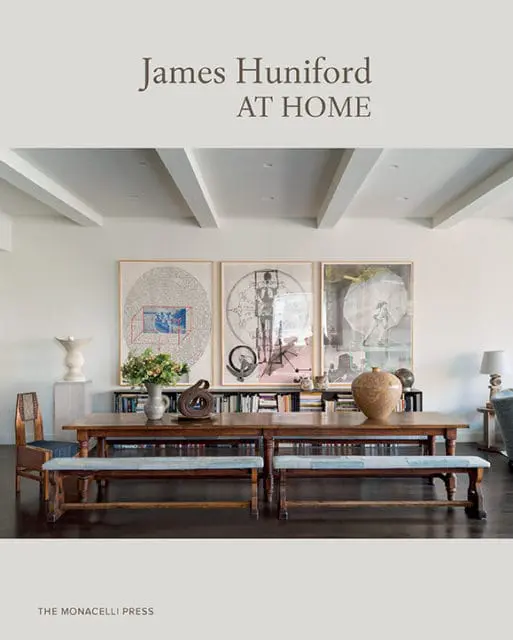 James Huniford AT HOME book cover featuring a dining room with a long wooden table, benches, and artwork on the wall.