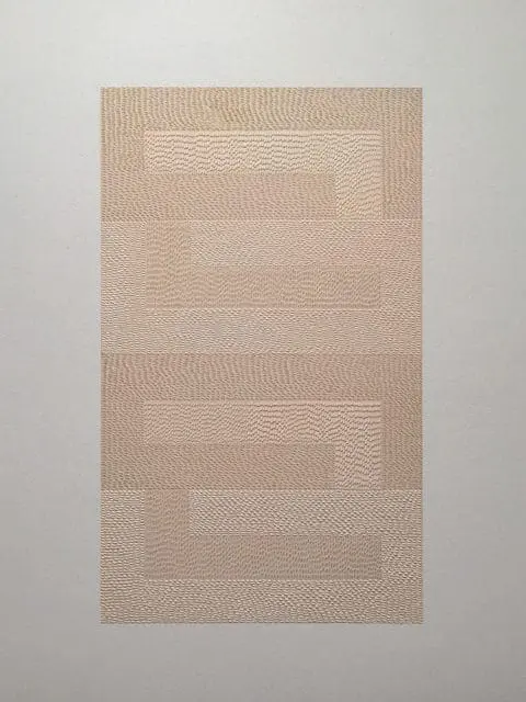 Close-up of a textured beige wallpaper with a repeating rectangular pattern and a subtle pebbled finish.