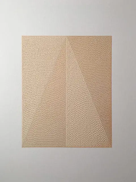 Close-up of a textured beige panel with a geometric pattern dividing it into two sections.