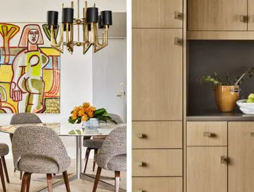 Dining area with abstract art and chairs, adjacent to a kitchen with light wood cabinetry and brass hardware.