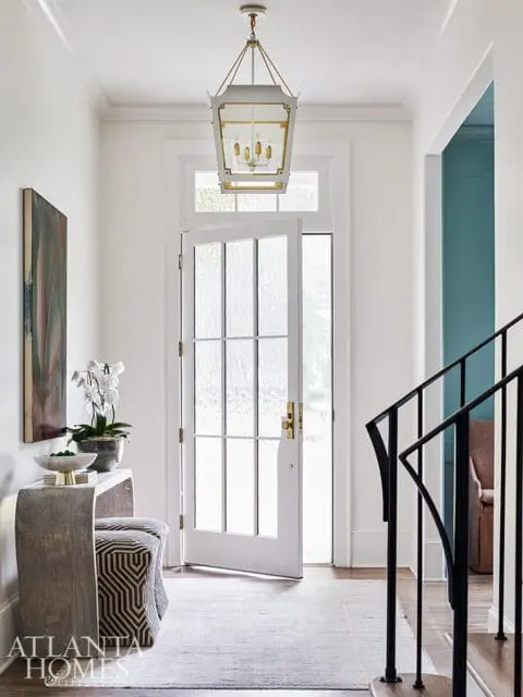 white foyer with lantern pendant