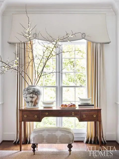 formal drapery over a writing desk