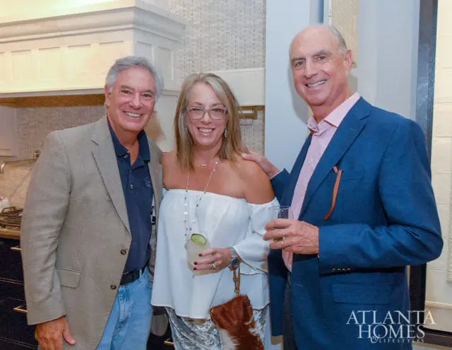 Three people smiling, with Atlanta Homes & Lifestyles logo in the corner.