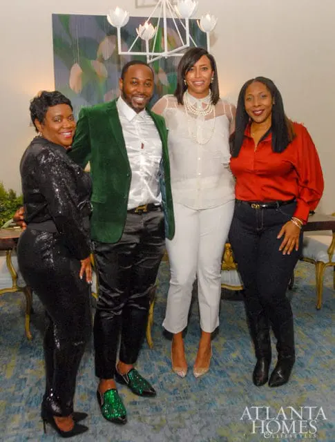 Four people posing indoors, with a logo for Atlanta Homes & Lifestyles in the lower right corner.