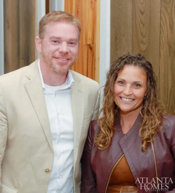 Man in tan suit and woman in burgundy jacket smiling, Atlanta Homes & Lifestyles logo