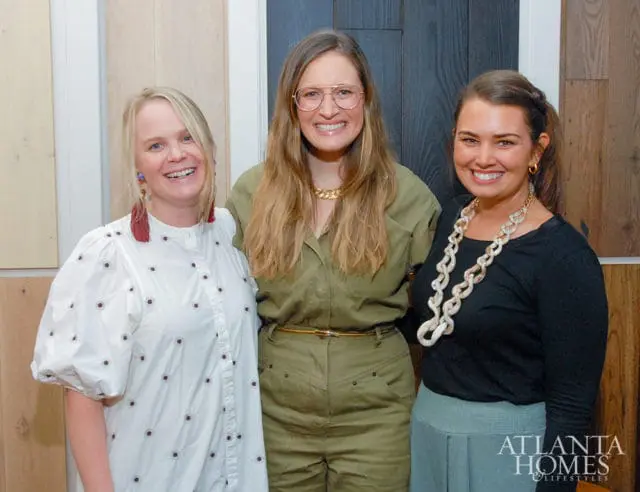 Three women smiling, with a logo for Atlanta Homes & Lifestyles in the lower right corner.