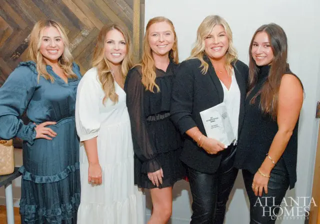 Five women posing for a photo. One holds a booklet titled "2021 Kitchen of the Year Winner".