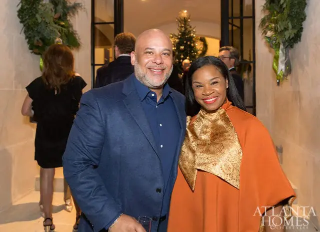 Dietrich Logan and Taninma Logan smiling, with a Christmas tree in the background.