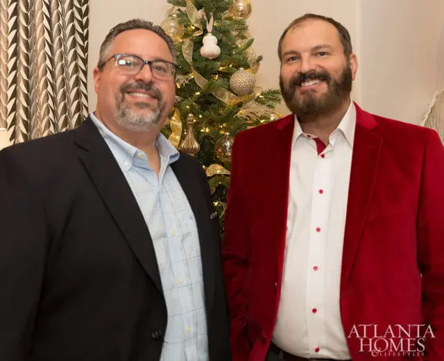 Andy Guerrasio and Carroll Robinson in front of a Christmas tree.