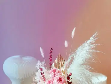 Pink roses and white hydrangeas in a red box with dried flowers and pampas grass