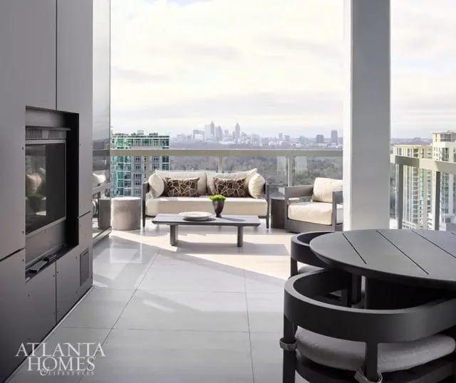 Balcony with city view, sofa, chairs, coffee table, and dining set.
