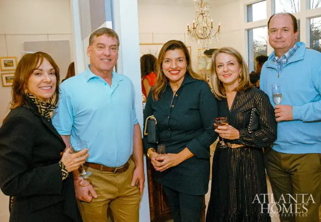 Five people posing for a photo, with the Atlanta Homes & Lifestyles logo in the bottom right corner.