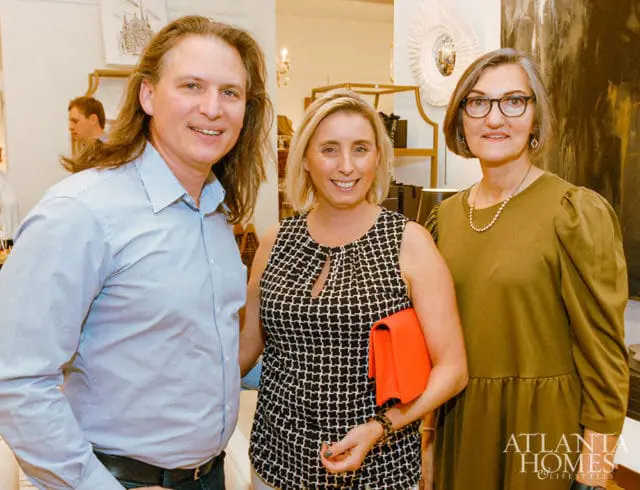 Three people posing for a photo, with Atlanta Homes & Lifestyles logo in the corner.