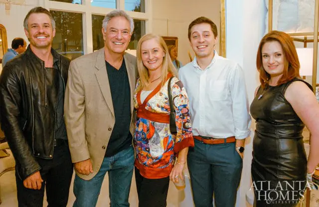 Five people posing for a photo indoors.