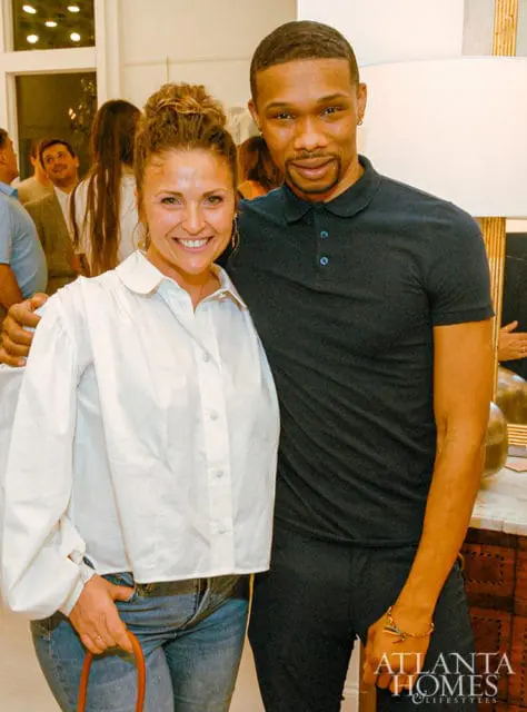 Woman in white shirt and man in black polo shirt smiling, Atlanta Homes & Lifestyles logo visible