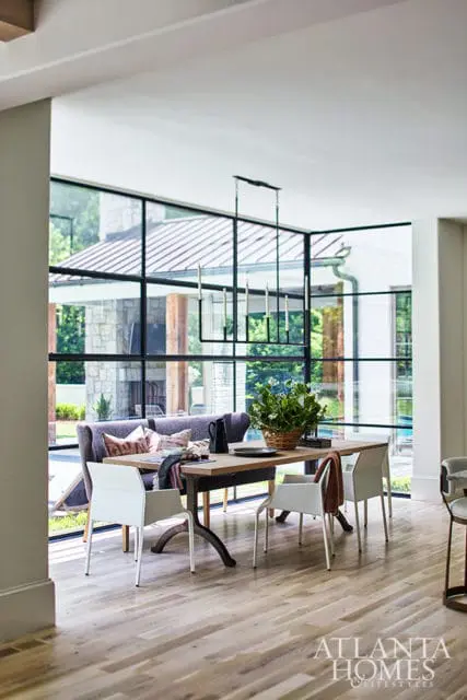 Dining room with wood table, white chairs, and purple banquette seating