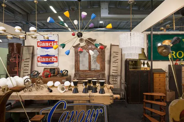 Multi-colored Sputnik chandelier above a wooden table with antique items