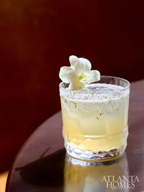 Cocktail with white orchid garnish and salt rim
