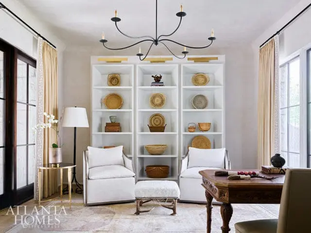 Living room with white built-in shelves displaying baskets and decorative objects.