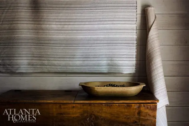 Wooden chest with striped fabric and bowl of dark beads