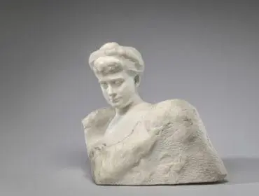 Marble bust of a woman with hair styled up, looking down.