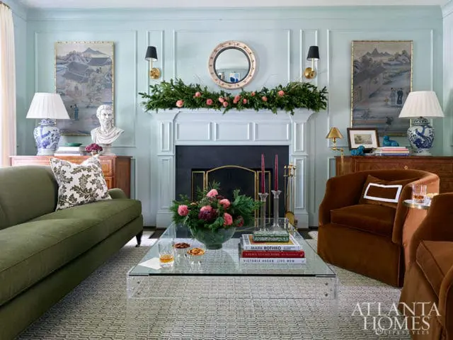 Living room with green sofa, brown chairs, fireplace, and acrylic coffee table