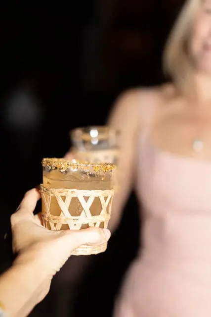 Cocktail with a sugar rim in a woven glass holder