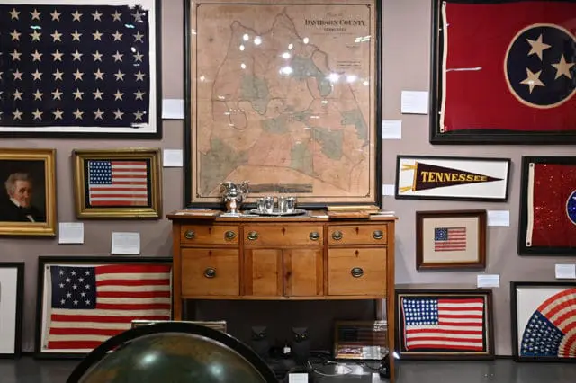 Collection of historical American flags, a map of Davidson County, Tennessee, and a portrait