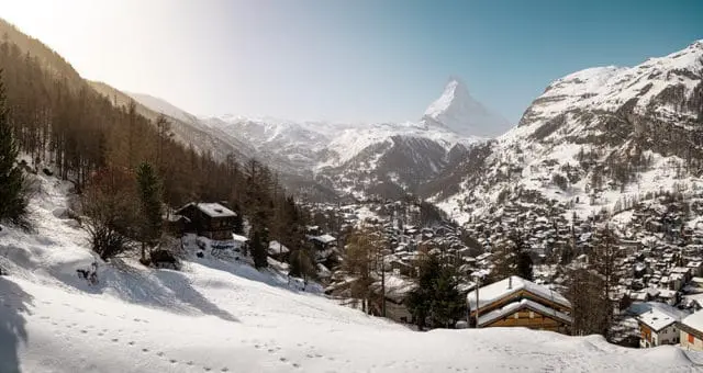 Snowy mountain village with Matterhorn peak in the distance.