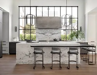 Modern kitchen with marble island, stainless steel range hood, and black bar stools. Large window