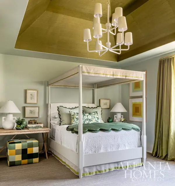 Bedroom with grasscloth ceiling, white canopy bed, and green accents.