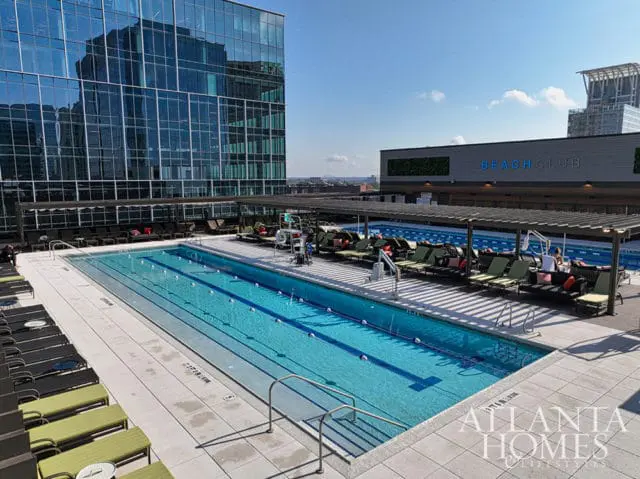 Rooftop pool with lounge chairs and a building labeled "BEACH CLUB"