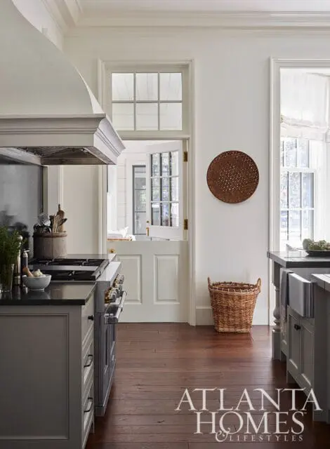 Gray kitchen with dark countertops, stainless steel range, and Dutch door.