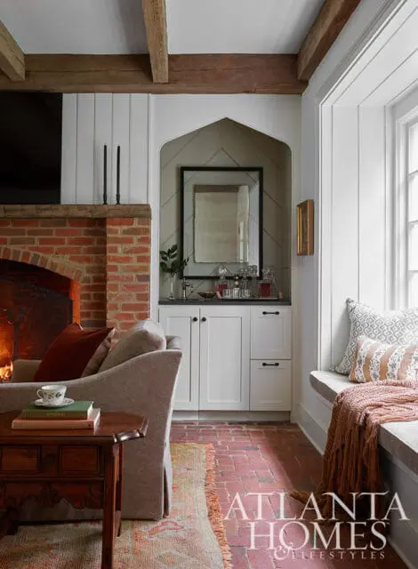 Living room with brick fireplace, built-in bar, and window seat.