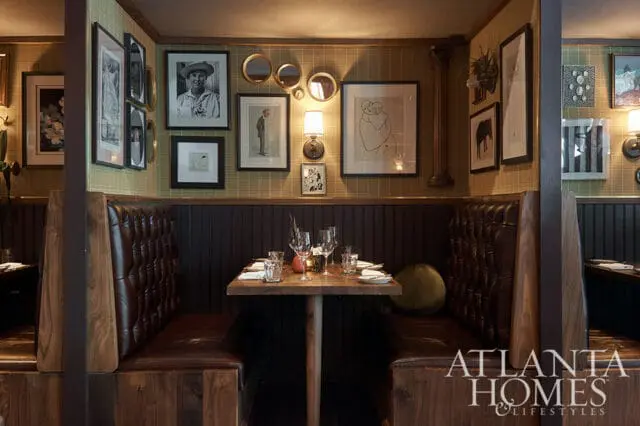 Restaurant booths with tufted brown leather seating and dark wood accents.