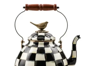 Black and white checkered tea kettle with a bird finial and wooden handle