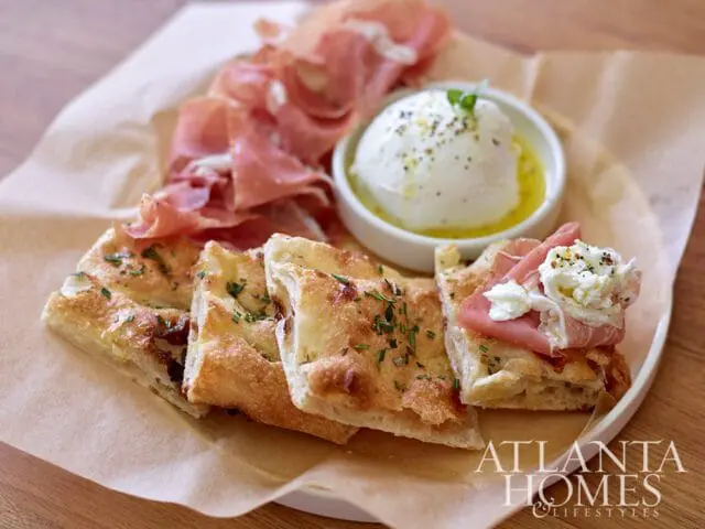 Focaccia bread with prosciutto and burrata cheese, Atlanta Homes & Lifestyles logo