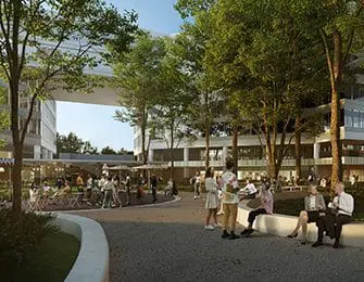 Modern buildings with people socializing outdoors in a courtyard with trees and seating areas.
